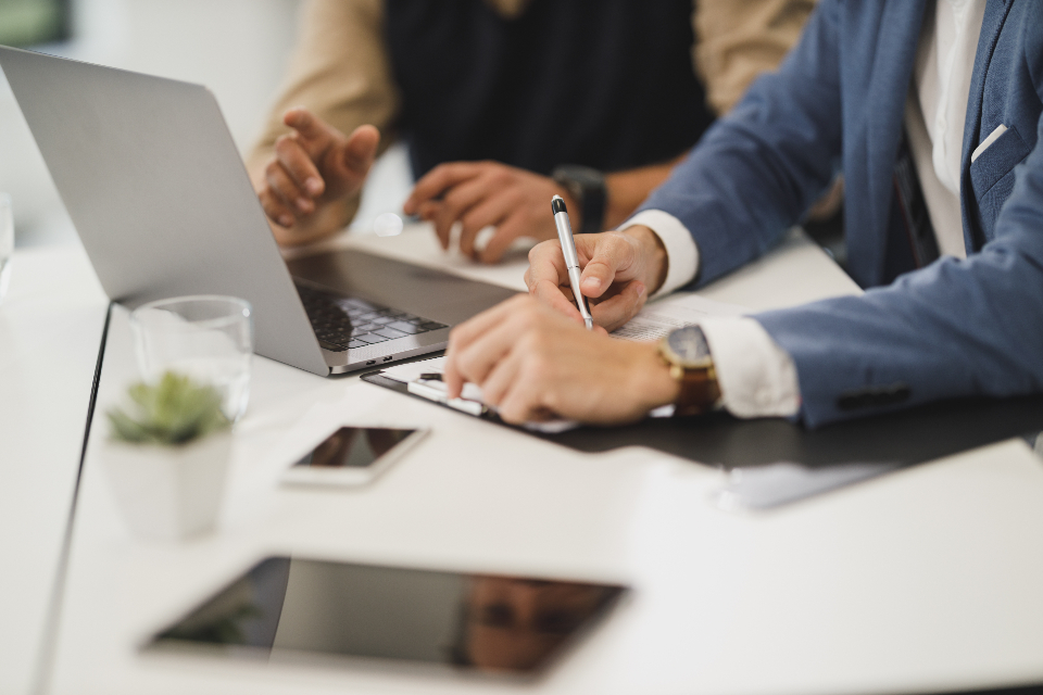 Two people reviewing documents at a desk